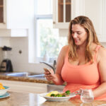 Weight loss supplements–do they work?: Hero Image Woman enjoying a healthy meal, reflecting the importance of a balanced diet and lifestyle changes in supporting weight loss efforts, alongside the the role of supplements in a weight management plan.
